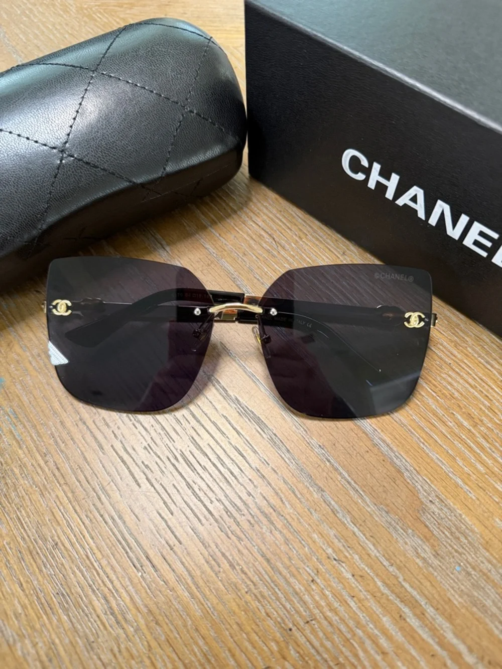 Chanel Women's Black and Gold Rimless Square Sunglasses